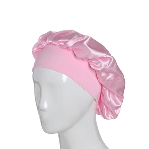 Pink satin sleep bonnet with wide elastic band on mannequin head, studio lighting