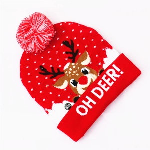 Detail of red knitted LED Christmas hat with reindeer pattern and Oh Deer text