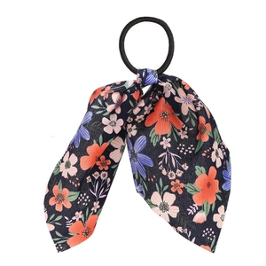 Close-up of floral bow hair tie with dark blue fabric and high elastic band