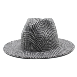 Close-up of the houndstooth pattern and thick wool texture on a wide brim fedora hat
