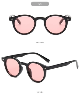 Detailed views of retro round black sunglasses with pink lenses and silver arrow accents