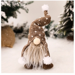 Detail of Christmas gnome plush featuring brown knit hat with white heart pattern