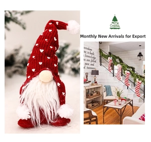 Detail of red knit gnome plush with white heart patterns and Christmas stockings scene