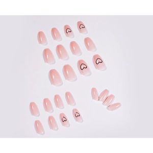 Short ballet nude ombre press-on nails with minimalist black heart patterns and glossy finish