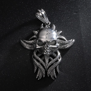 Gothic stainless steel skull pendant with feather textures on dark glitter background