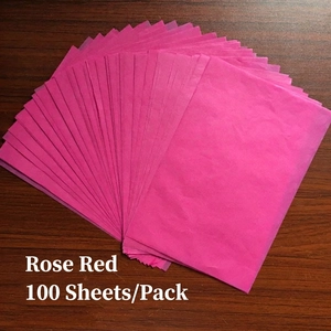 Macro detail of 100 sheets pack rose red tissue paper fanned out on wood surface