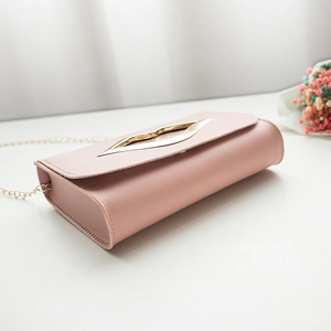 Chic pink leather crossbody bag with a golden lip-shaped clasp and metal chain strap