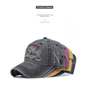 Detail showing vintage washed cotton baseball caps with 3D York 1985 embroidery in multiple colors