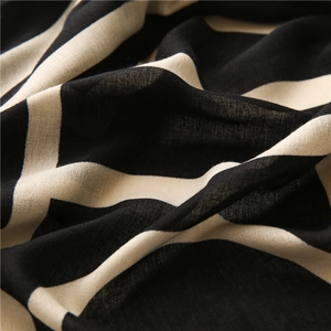 Macro detail of the lightweight woven fabric showing black and beige geometric stripes