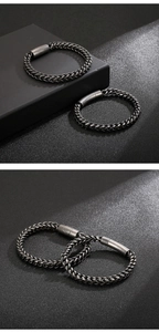 Detail of vintage punk braided stainless steel bracelets in silver and gunmetal black