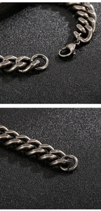 Detailed close-up of retro silver stainless steel Cuban link bracelet with lobster clasp