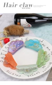 Detailed close-up of cloud hair claws in macaron colors with gold moon and star details