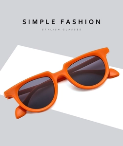 Detailed 45-degree angle of orange full-frame retro sunglasses with dark polarized lenses
