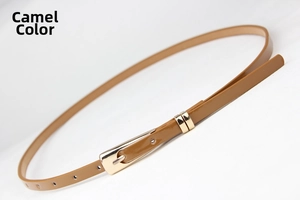 Detail of camel leather slim belt for women with polished gold metal buckle on white background