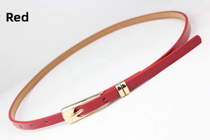 Detail of slim red leather belt with gold square buckle and adjustable holes on white base