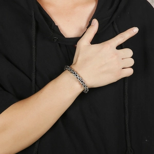 Mens vintage stainless steel Byzantine chain bracelet on model with black hoodie background