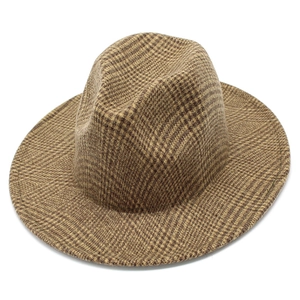 Detailed close-up of brown houndstooth tweed fedora with classic indented crown texture