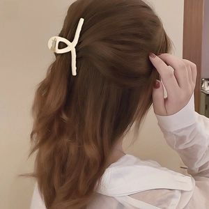 Elegant matte cream large hair claw clip styling on brunette wavy hair for women