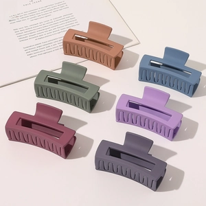 Detailed set of six large matte hair claws in diverse Morandi colors with hollow design
