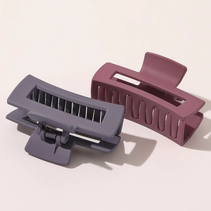 Detail view of large matte rectangle hair claws in purple and grey morandi colors