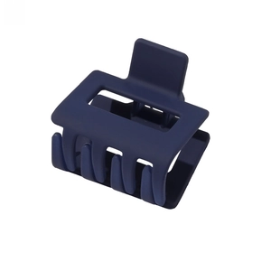 Detail of large matte navy blue square hair claw clip with cross-teeth design