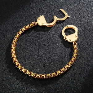 Gold stainless steel box chain bracelet featuring unique interlocking handcuff charms