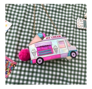 Detailed close-up of ice cream truck crossbody bag with laser finish and pink pom-pom