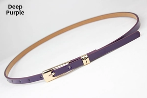 Detail of dark purple skinny belt featuring glossy finish and gold metal buckle