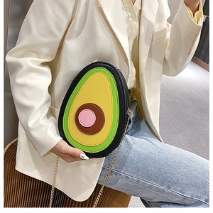 Detail of creative avocado cross body bag with metal chain strap and colorful PU leather