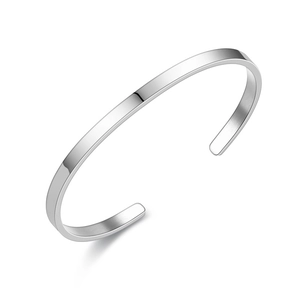 Macro shot of minimalist silver stainless steel C-shaped open cuff bracelet texture
