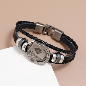 Detailed shot of braided leather bracelet with vintage bronze poker card charms