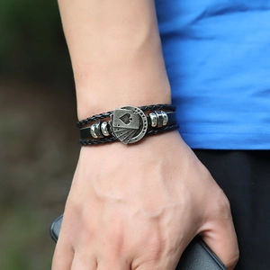 Men's multi-layer braided black leather bracelet with metal poker aces charm on wrist