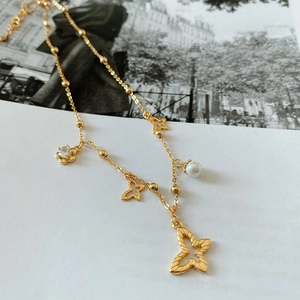 Detail of 925 silver golden butterfly necklace with white pearl and clear gemstone