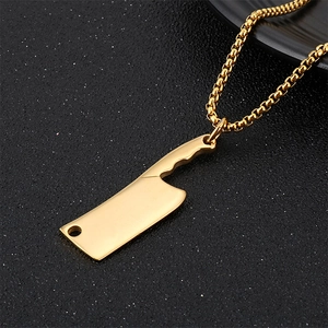Close-up of golden cleaver knife pendant on box chain with a polished metallic finish