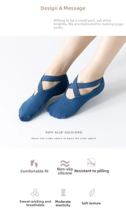 Blue yoga socks featuring criss-cross straps and anti-slip silicone dots on the bottom