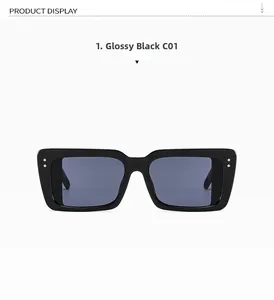 Close-up of oversized square sunglasses featuring black frames and silver metal studs