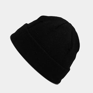 Detail showing the fine rib-knit texture and folded cuff of this black winter beanie hat