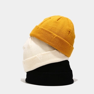 Distressed knit skull caps in yellow, beige and black with vintage ripped edge details