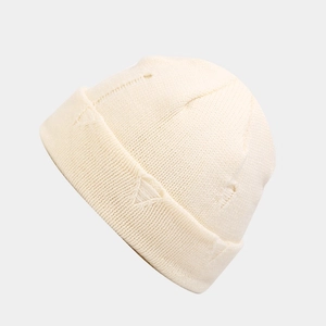 Detail of cream white distressed knit beanie showing vertical ribbed texture and cuff