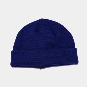 Macro detail of royal blue knitted beanie showing the fine texture and wide folded cuff edge