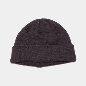 Detail of distressed knit beanie with ribbed texture and stylish ripped hole design