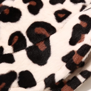Detailed macro view of soft faux fur fabric with classic leopard print pattern