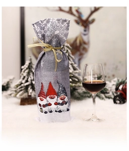 Detail of Christmas wine bottle cover featuring grey linen and three cute forest gnomes