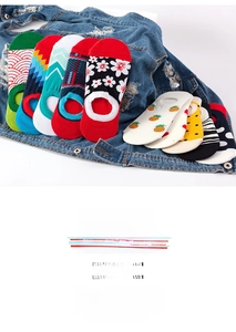 Flat lay of cotton invisible boat socks with colorful patterns on denim jacket