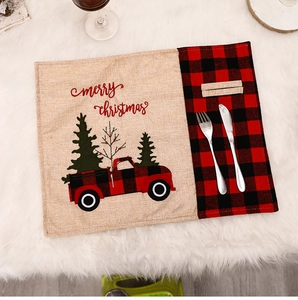 Detail view of burlap Christmas placemat with red truck and cutlery holder pocket