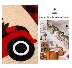 Detail of burlap Christmas placemat featuring a red vintage truck and plaid patterns