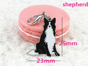 Detail view of Border Collie pendant with lobster clasp on soft white plush background