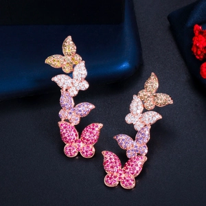 Macro shot of rose gold butterfly climbing earrings with gradient cubic zirconia stones