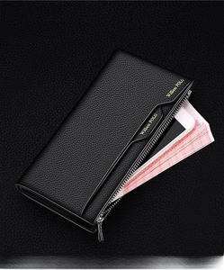 Macro shot of black litchi grain leather wallet showing large capacity for phone and bills