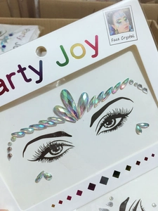 Detailed close-up of iridescent AB crystal face jewels with adhesive backing for makeup
